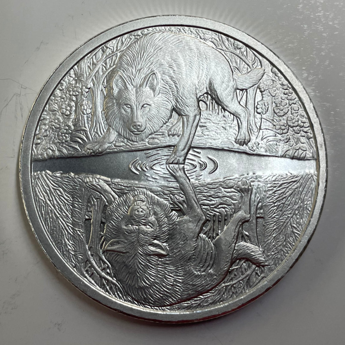 Two Wolves by Pheli Mint., 1oz .999 Fine Silver BU Round